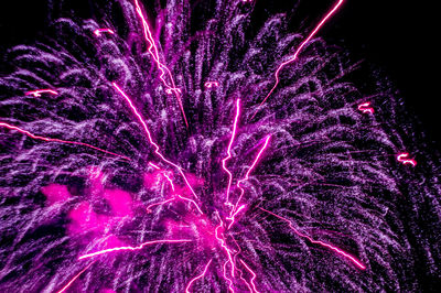 Low angle view of firework display at night