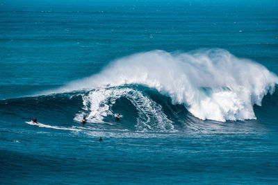 People surfing in sea