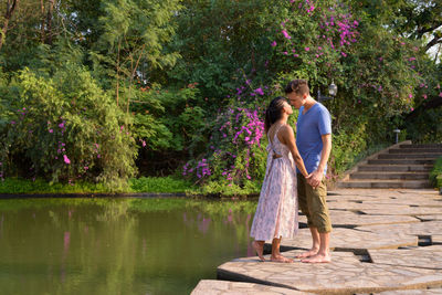 Rear view of couple standing by plants