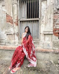 Bangladeshi woman sitting near an old building