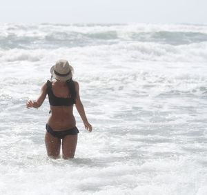 Woman wearing hat at sea