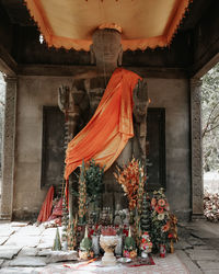 Statue by temple against building