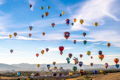 Low angle view of balloons flying against sky