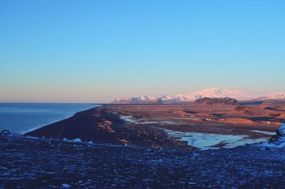 Scenic view of sea against clear sky during sunset