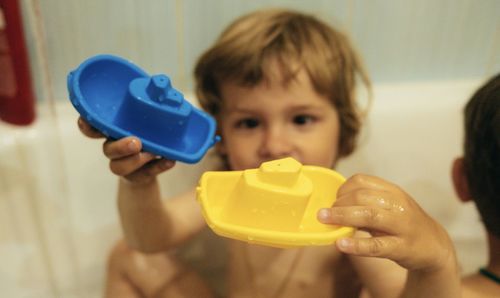 Close-up of boy holding bottle