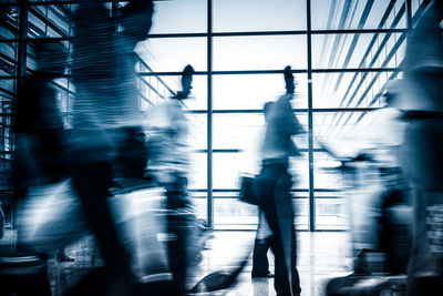 People walking on modern building in city