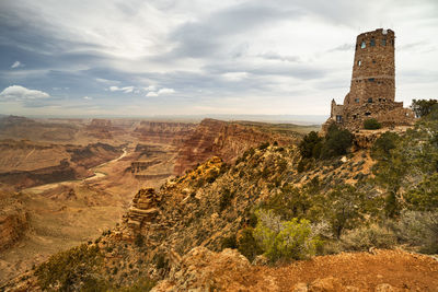 View of castle on mountain against cloudy sky