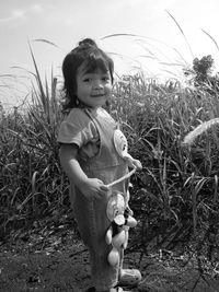 Cute girl standing on field