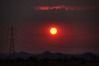 Silhouette landscape against sky during sunset