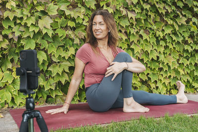 Portrait of a smiling young woman sitting outdoors