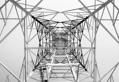 Low angle view of electricity pylon against clear sky