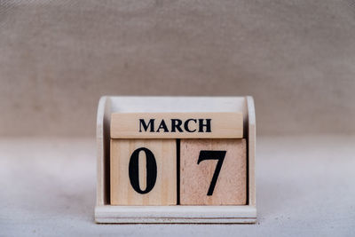 Close-up of information sign on table