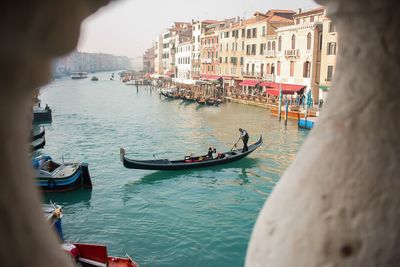 Boats in canal along city