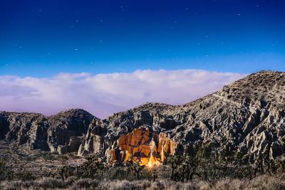 Panoramic view of illuminated mountain against sky at night