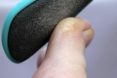 Cropped foot of person with nail file