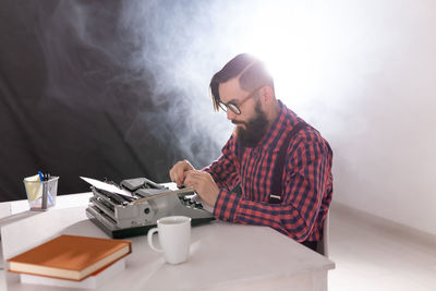 Man and coffee cup on table