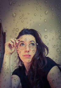 Portrait of young woman in rain