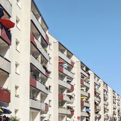 Low angle view of buildings against clear blue sky