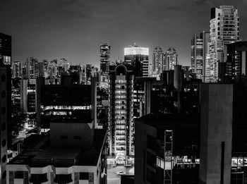 View of skyscrapers in city at night