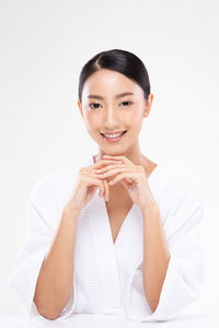 Portrait of a smiling young woman over white background