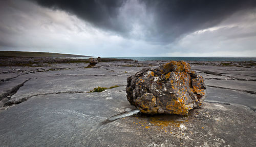 Rocks on beach against sky