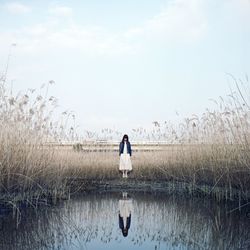 Full length of man on bird against sky