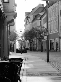 Empty street amidst buildings in city