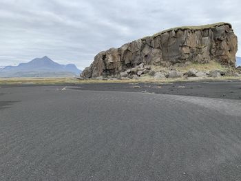 Road leading towards mountains against sky
