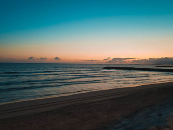 Scenic view of sea against clear sky during sunset