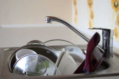 Close-up of kitchen utensils in sink at home