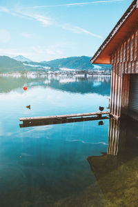 Wooden fishing house on the coast of the lake tegernsee. alpine mountains in bavaria.