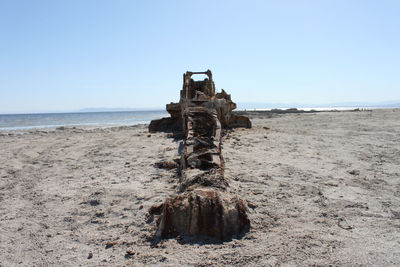 Abandoned built structure on shore against clear sky