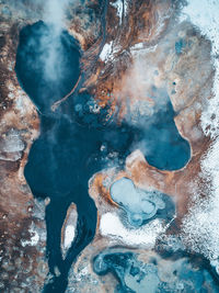 Aerial view of steam emitting from hot spring