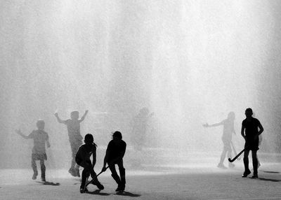 Young hockey players in action during  rain downpour