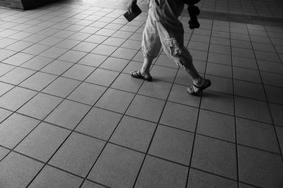 Low section of man walking on floor