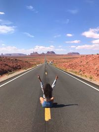 Rear view of man on road against sky