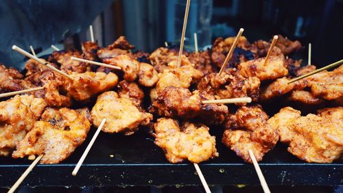 Close-up of fried chicken with toothpicks on tray