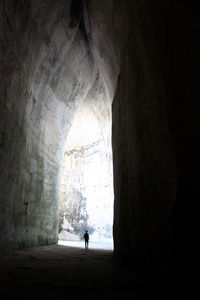 Silhouette woman standing in tunnel