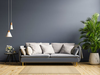Cozy modern living room interior have sofa on empty dark wall background.3d rendering