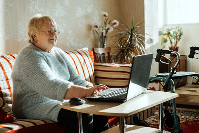 Man sitting on table at home