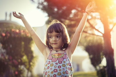 Little girl having fun outdoors in sunset