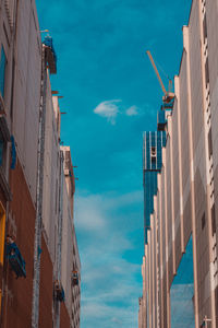 Low angle view of buildings against blue sky