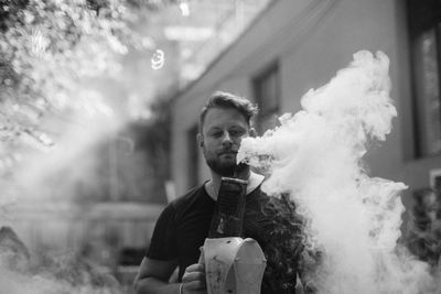 Portrait of young man smoking