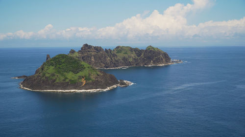 Small rocky islands in the sea, blue sky and clouds. dos hermanas, palau, santa ana. 