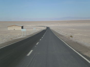 Empty road along trees