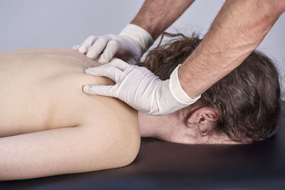 Midsection of man lying on hands