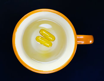 Directly above shot of coffee cup against black background