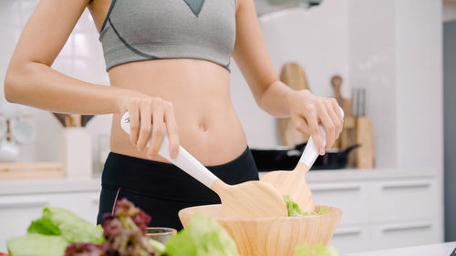 Midsection of woman holding bouquet