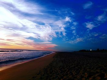 Scenic view of beach against sky during sunset