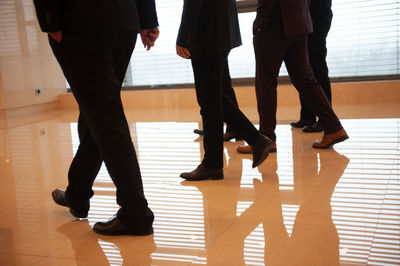 Low section of people walking on floor